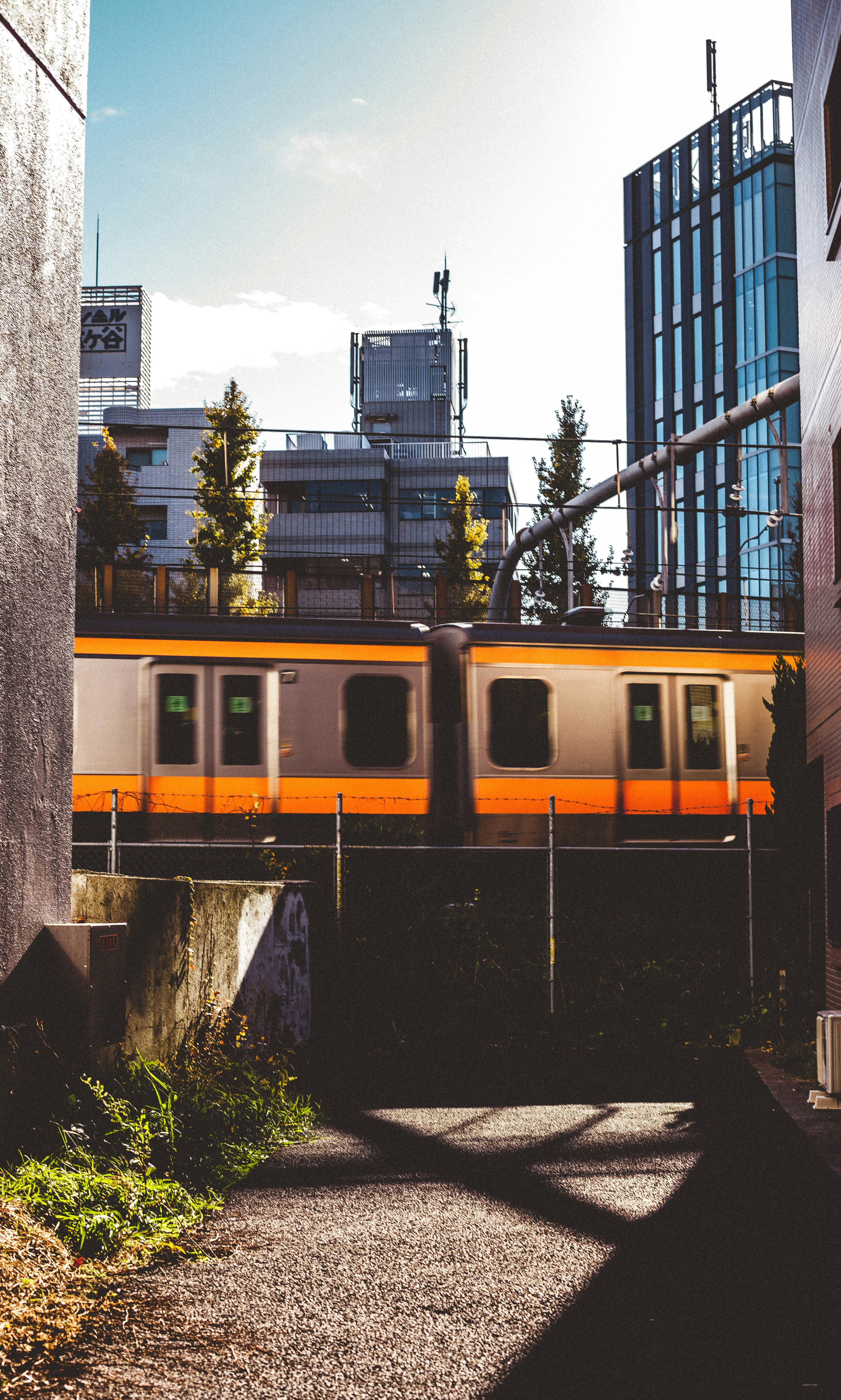 grey and orange train during daytime